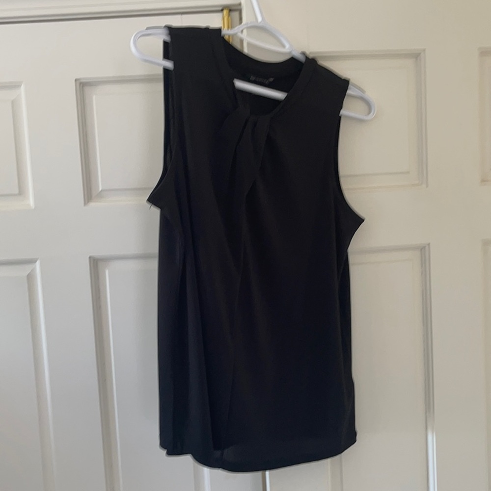 Simple black top with neck detail.